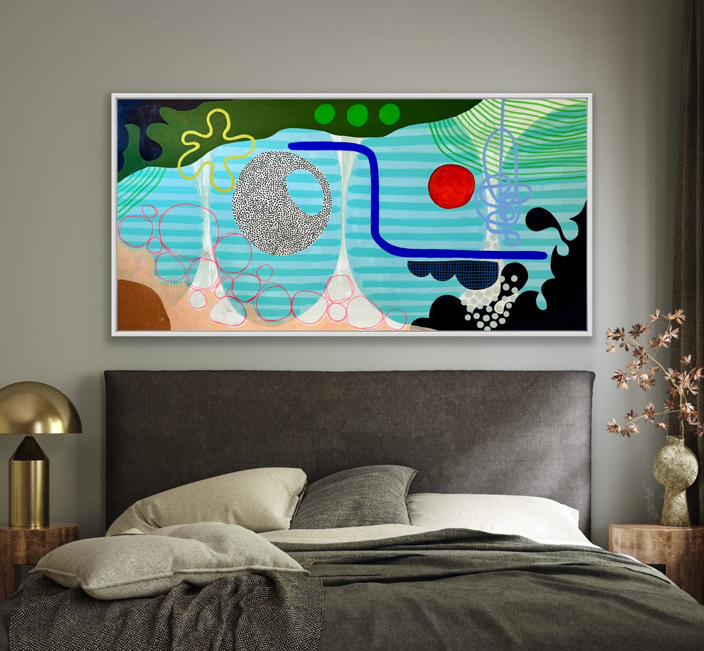 Abstract artwork on a wall above a bed in a bedroom setting