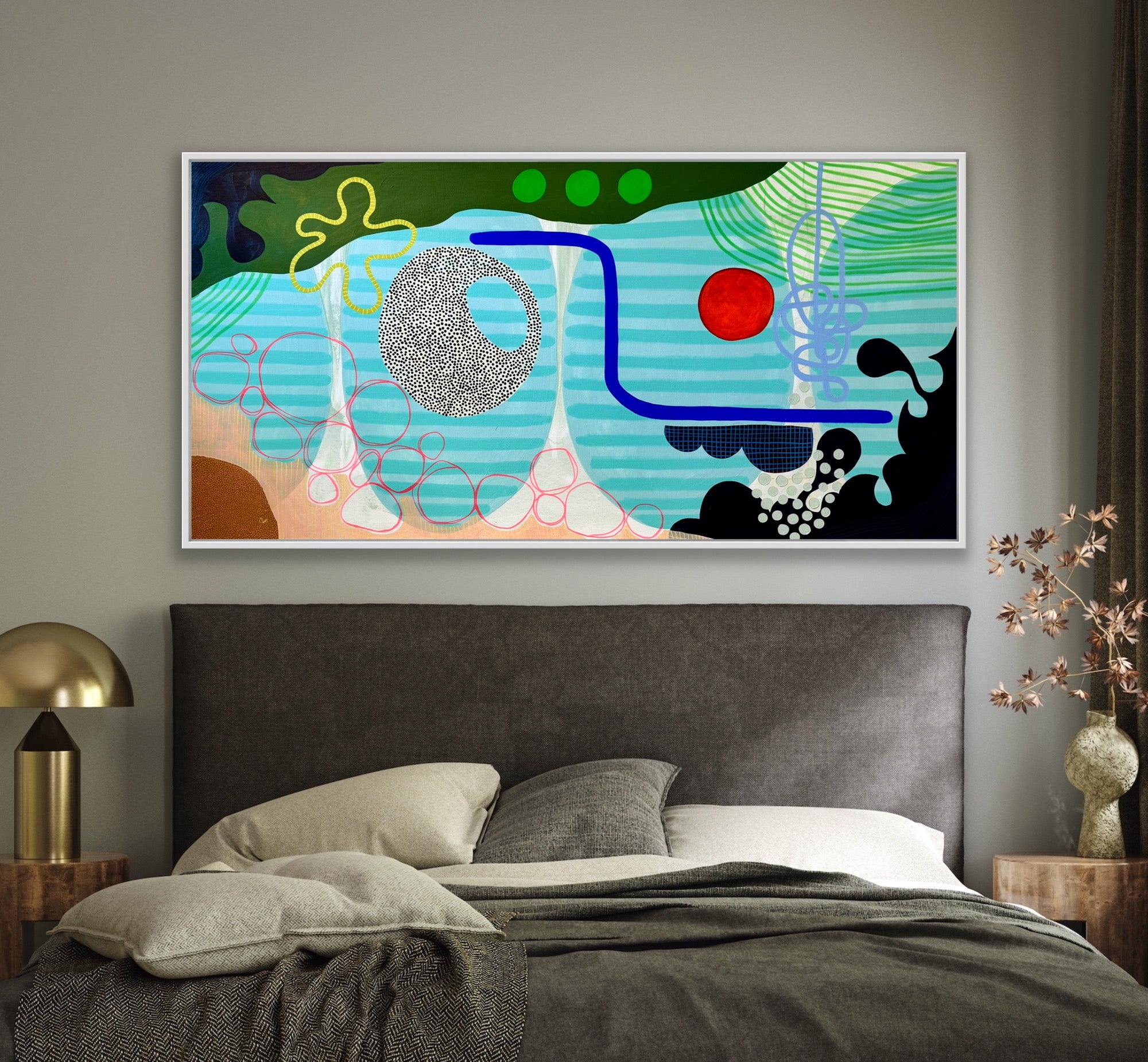 Abstract artwork on a wall above a bed in a bedroom setting