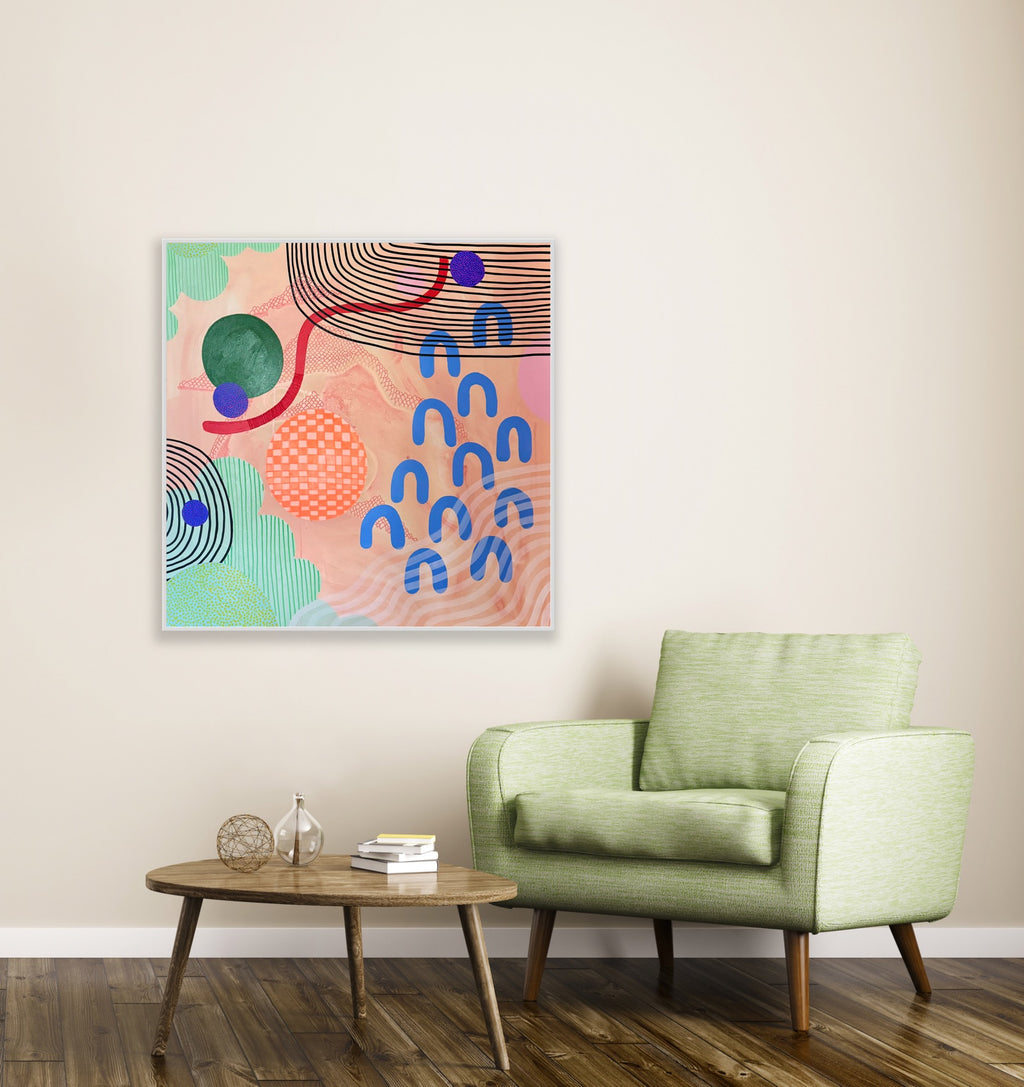 Modern living room with a green armchair, wooden coffee table, and abstract art on the wall.