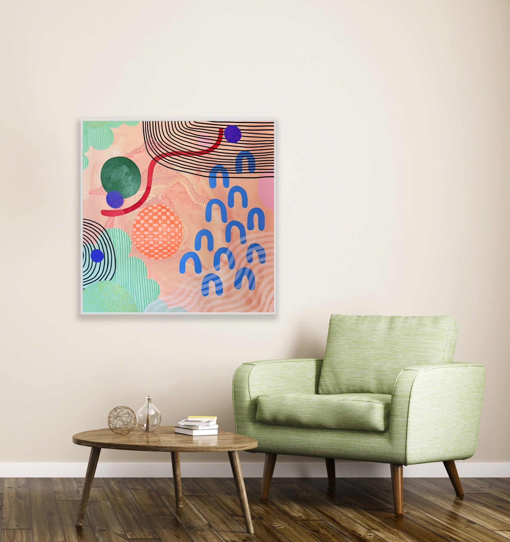 Modern living room with a green armchair, wooden coffee table, and abstract art on the wall.