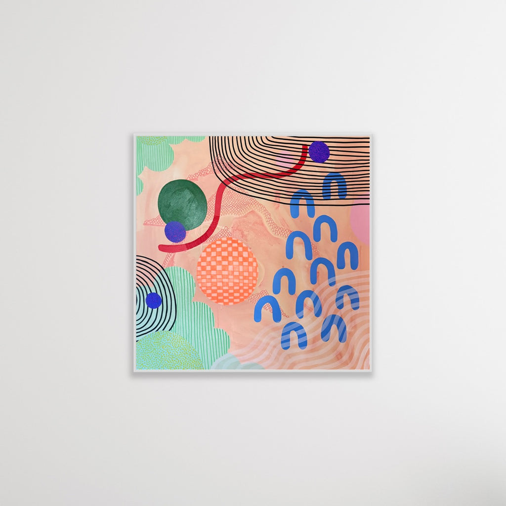Abstract art print with colorful shapes on a white wall