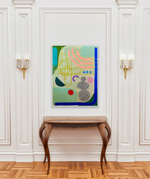 Abstract painting on a wall above a wooden console table in a room with white walls and wooden flooring.