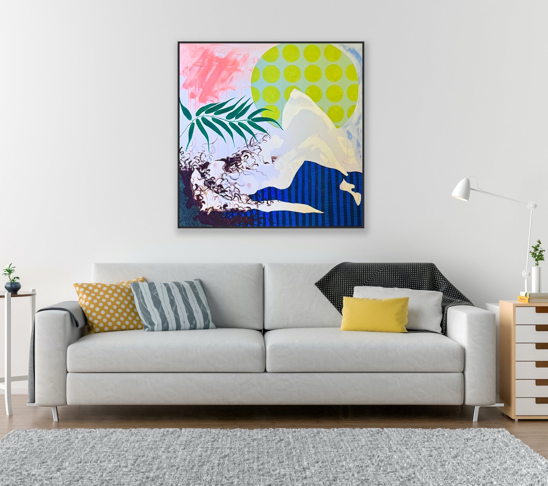 Modern living room with a gray sofa, colorful abstract painting, and decorative pillows.